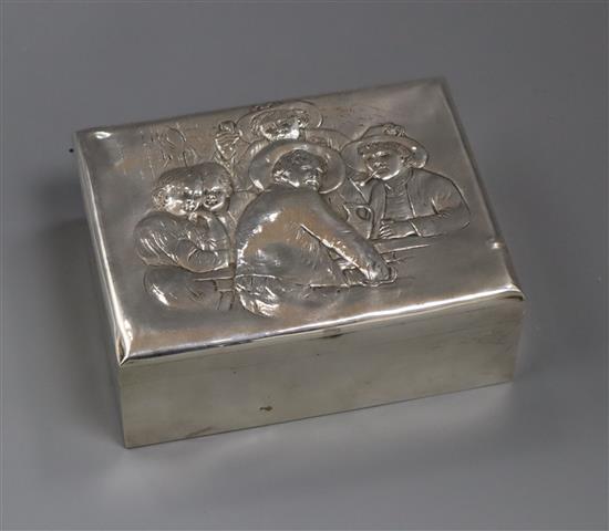 A George V silver cigarette box, embossed with imbibers, London, 1926, 12.7cm.